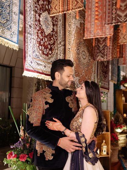 A romantic portrait of the couple, framed by the rich textures of the hanging Persian rugs that formed the backdrop for their event.