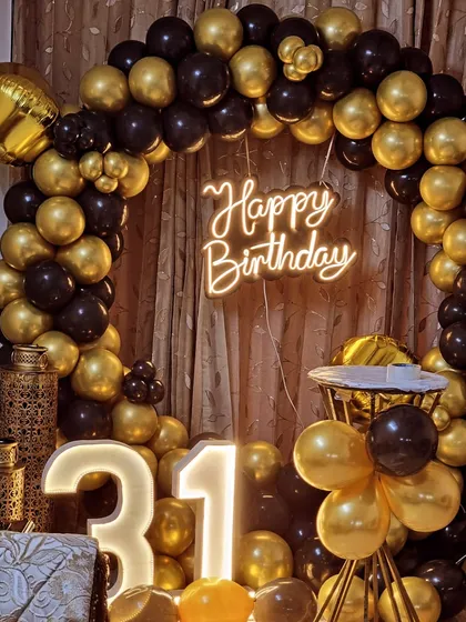 A close-up of the neon sign and balloon details for the 31st birthday setup.