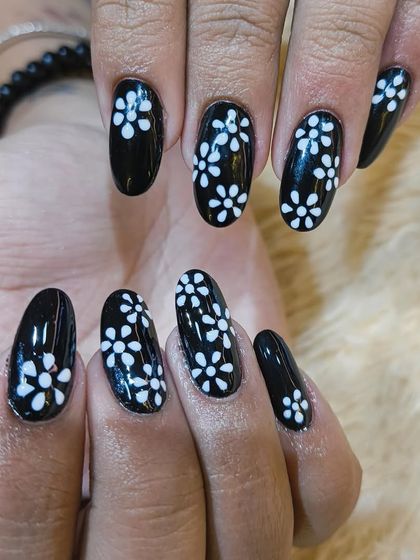 A detailed shot showcasing the fine brushwork in our hand-painted floral nail art. We take pride in our precision to ensure every detail is perfect.