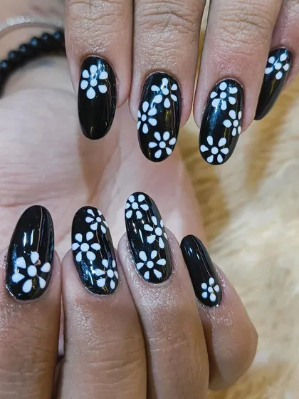 A detailed shot showcasing the fine brushwork in our hand-painted floral nail art. We take pride in our precision to ensure every detail is perfect.