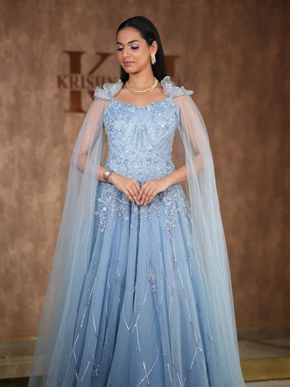 A modern, fashion-forward look featuring a pearl-encrusted gown. The simple diamond drop earrings are the perfect accessory for this statement outfit.