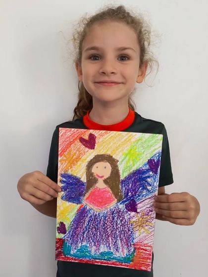 A beautiful angel drawing with a vibrant rainbow background, created with oil pastels.