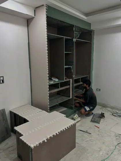 Another on-site photo of a wardrobe being built. The internal compartments for shelves and drawers are configured based on the client's specific storage requirements.