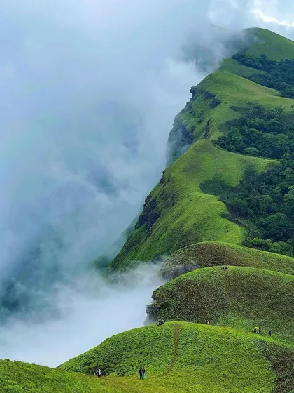 The stunning, sharp ridge of Netravathi peak, half-covered in clouds.
