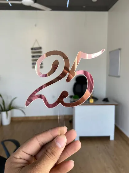 A simple yet elegant "25" topper in rose gold, perfect for a 25th birthday or anniversary celebration.