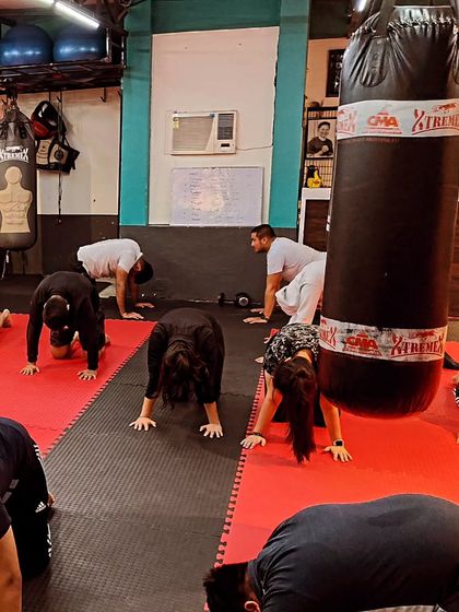 A moment from our warm-down sequence. The entire group moves together, stretching out after a hard workout. This is essential for recovery and preventing injury.