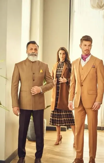 A display of timeless elegance. This image features a classic tan Jodhpuri suit and a three-piece suit, showcasing our expertise in crafting sophisticated formal wear for the modern gentleman.