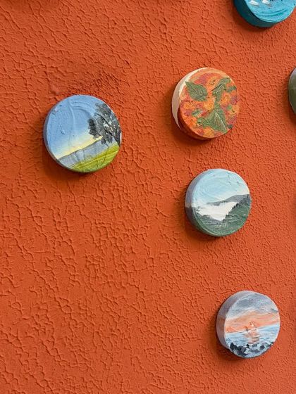 An angled view showing the three-dimensional quality of the miniature art pieces as they sit on the main board.