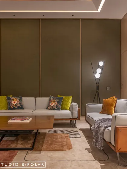 For this lounge, we used a rich olive green fabric on the walls to create a dramatic and sophisticated backdrop. Modern furniture in neutral tones with pops of color in the cushions keeps the space feeling fresh and inviting.