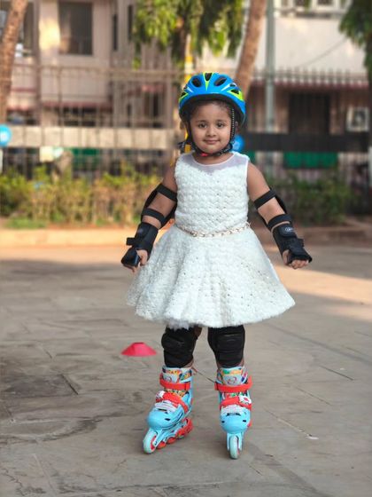 A beautiful white dress paired with skates and safety gear. Our fashion show is all about combining style with sport.