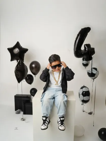 This little model is turning four with some serious style. With sunglasses and a cool pose, he's ready for his close-up in this football-themed birthday shoot.