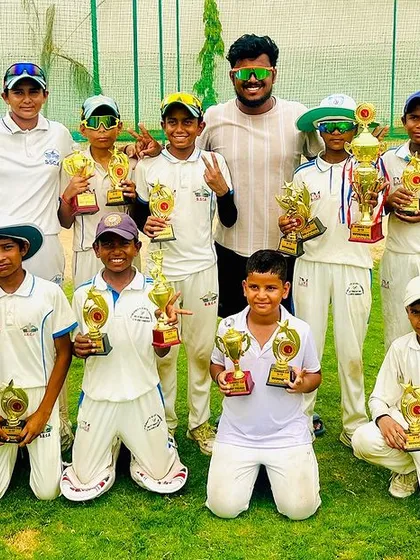 The whole team together with their trophies. This picture captures the spirit and success of our academy.