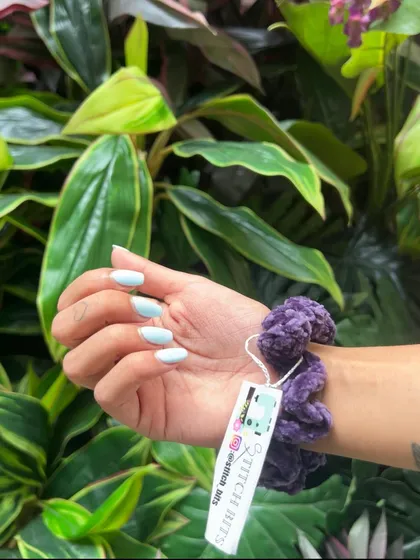 A deep purple velvet scrunchie, adding a touch of moody color to the collection. You can also see my branded tag, which I attach to each piece.