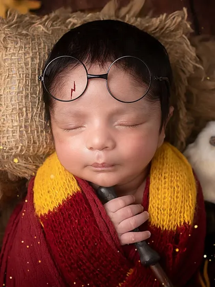 A close-up of our little wizard. The iconic lightning bolt scar and round glasses are the perfect finishing touches for this magical newborn photo.