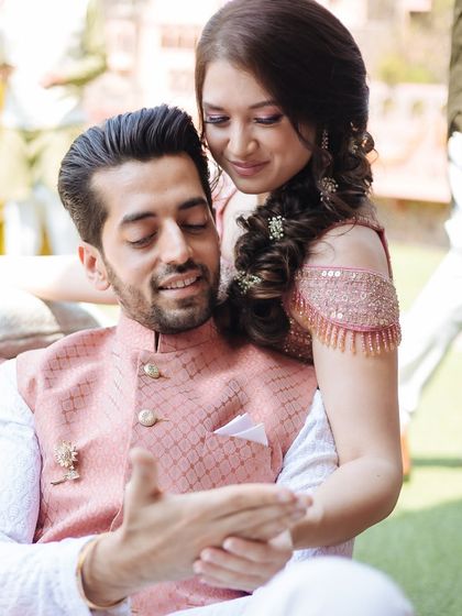 A sweet, candid moment between the bride and groom during their Mehendi at Fort Neemrana.