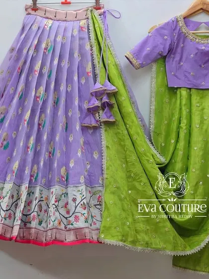 A deconstructed view of a lavender lehenga set with a bird-print skirt and a green dupatta.