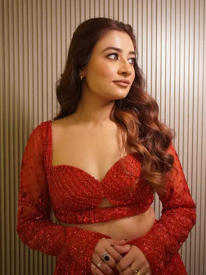 A closer look at the beautiful sweetheart neckline and sheer sleeves of our new red sequin lehenga. The craftsmanship is designed to make you feel confident and glamorous.