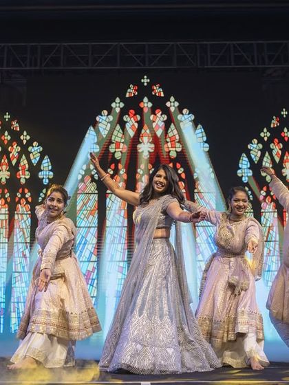 All things glam. A bride's solo with her backup dancers, set against a stunning stained-glass window visual. Pure elegance and style.