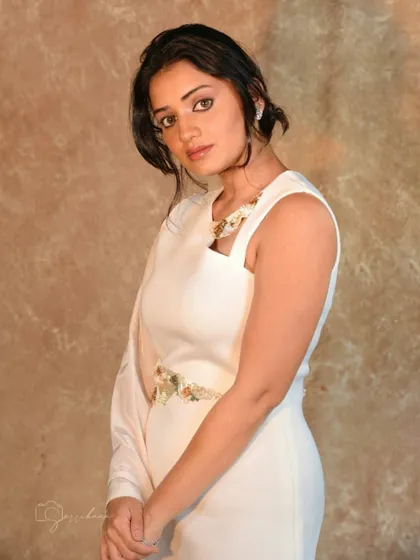 Styling Hruta Durgule in this elegant one-shoulder white gown. The design features a single flowing sleeve and intricate embellishments for a touch of contemporary glamour.