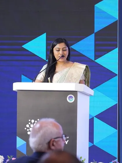Focused on my script during a formal address. Meticulous preparation is key, and I ensure every detail, from the script to speaker introductions, is flawless.