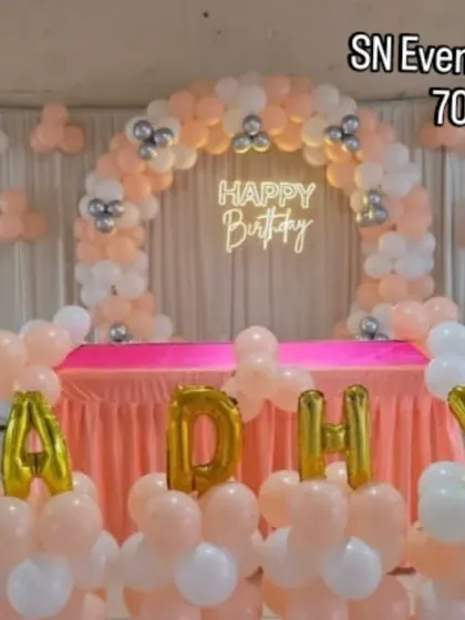 A lovely peach and white balloon arch with a neon sign. This setup is perfect for a small party or as a photo corner, providing an elegant look at an affordable price.