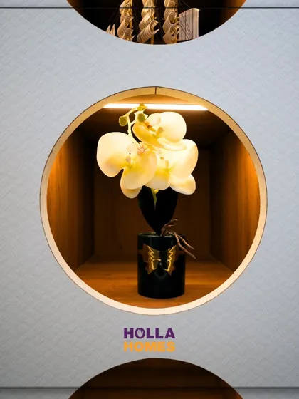 A close-up of the decorative circular niches built into the wardrobe, perfect for displaying small treasures like a model ship or a decorative flower.