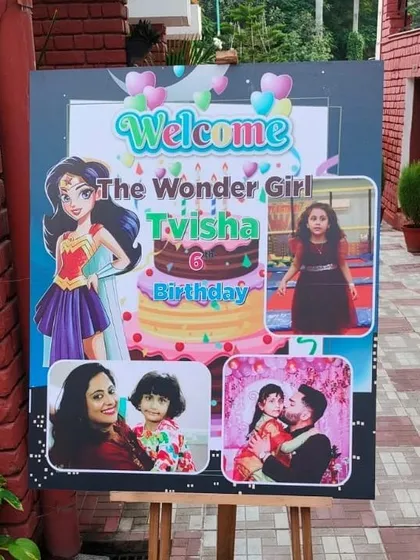 Welcome boards add a personal touch right from the entrance. This 'Wonder Girl' themed welcome board for Tvisha's 6th birthday features her photos alongside a superhero graphic, setting the stage for a powerful and fun party.