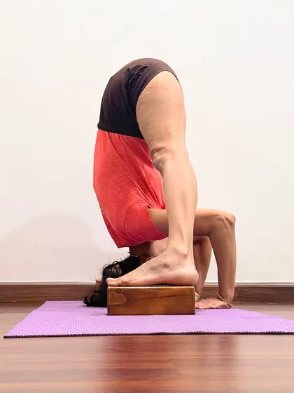 A student practicing Sirsasana. I did not score pass marks at school, but yoga has led me to discover the world. I treat the practice as part of my life, allowing it space within my normal activities.