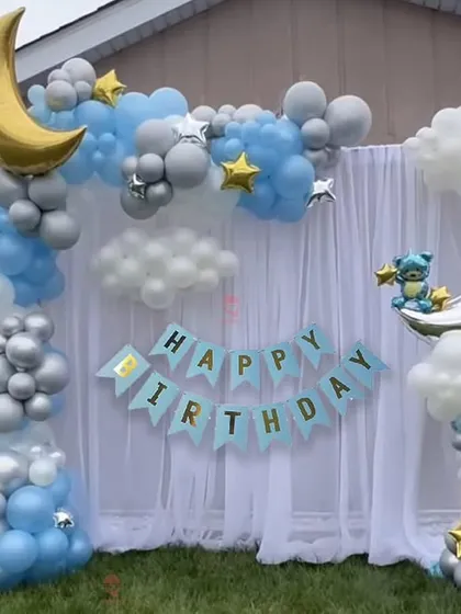 A dreamy "Twinkle Twinkle Little Star" theme with a moon and clouds. The blue, silver, and white balloons create a peaceful night-sky effect.