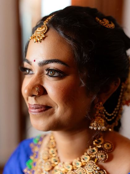 A close-up showcasing the defined eyes and flawless skin. The subtle wing liner and soft eyeshadow enhance her beautiful eye shape.