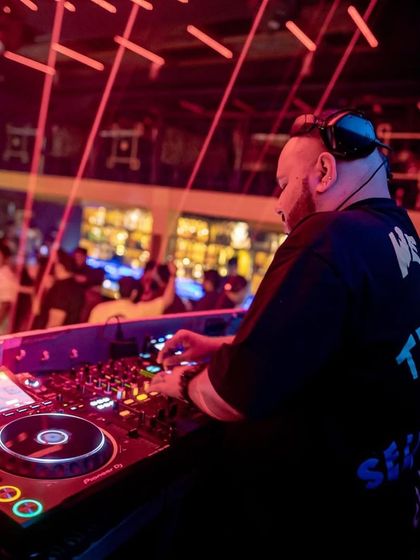 Behind the decks with the lasers firing. This shot captures the dynamic atmosphere of my club sets, where the lighting production is a key part of the show.