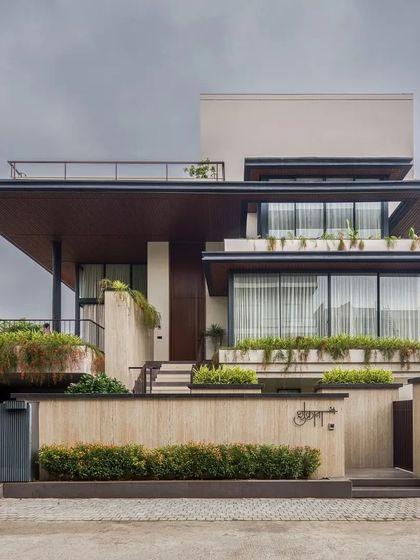 The residence showcases a strong horizontal emphasis with deep, cantilevered roof overhangs that provide shade and create dramatic lines.