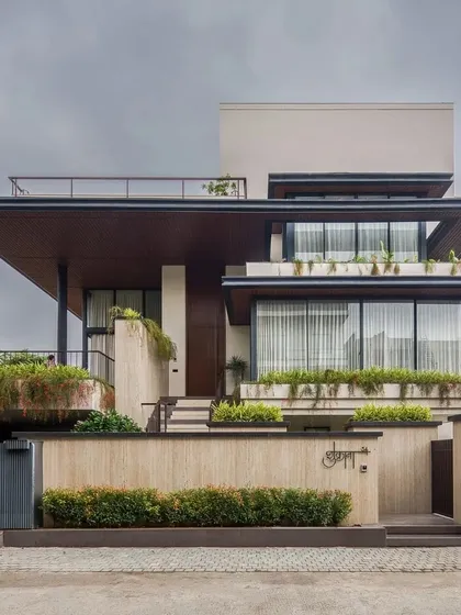 The residence showcases a strong horizontal emphasis with deep, cantilevered roof overhangs that provide shade and create dramatic lines.