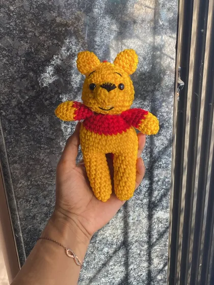 A sunny day shot of the Winnie the Pooh doll. The natural light really brings out the vibrant yellow of the yarn.