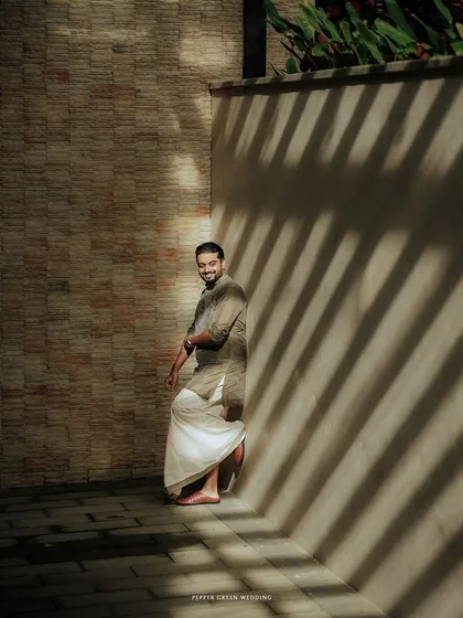 A stylish shot of the groom, the play of light and shadow creating a dramatic and interesting portrait.