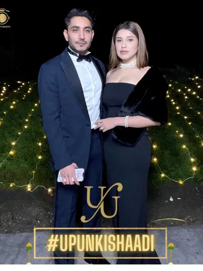 The happy couple looking sharp and glamorous for their gala dinner in Kathmandu, complete with a custom branded photo frame.