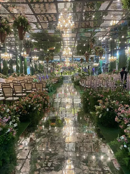 We love a challenge, and transforming an ancestral indoor hall into this magical, overgrown garden was a dream. With a mirrored ceiling reflecting thousands of blooms and chandeliers, we created an immersive environment to kick off the wedding festivities.