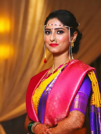 The quintessential Marathi bride. I focused on creating a bold red lip and sharp winged liner, paired with the traditional 'mundavalya' forehead accessory.