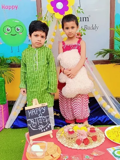 Posing for a picture on Rakshabandhan. The children loved our special setup with a 'Happy Rakshabandhan' slate and festive decorations.