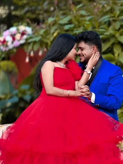 This is what a perfectly coordinated couple's photoshoot looks like. I offer matching rental outfits, like this stunning red gown and the sharp royal blue suit, so you can achieve a cohesive and romantic look without any hassle.