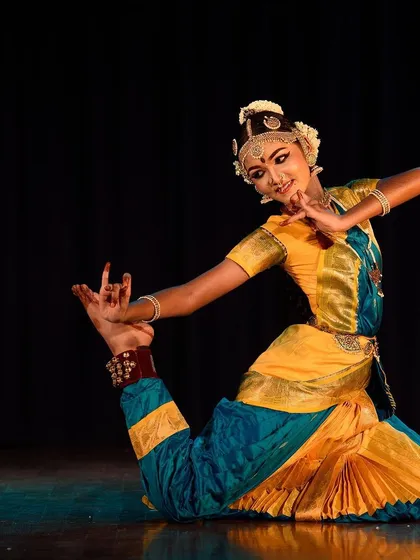 We believe dance is a powerful form of expression. Here, one of our senior students showcases the incredible flexibility and grace honed through dedicated Bharatanatyam training, capturing a moment of pure artistry on stage.