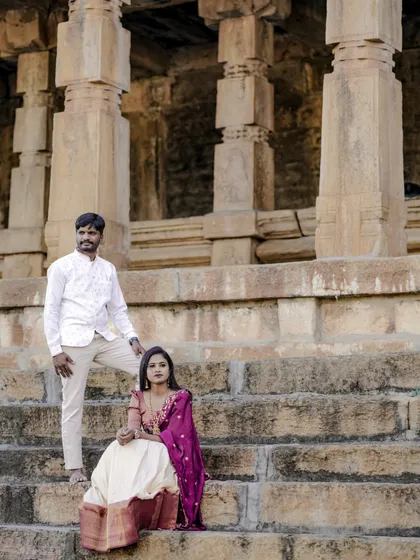 A majestic pre-wedding portrait. The couple's pose and traditional outfits create a sense of royalty and heritage.