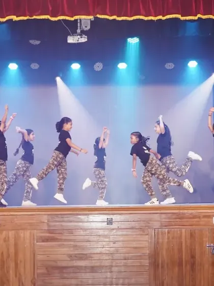 A wide shot of the kids' hip hop routine, showing their impressive synchronization and stage presence.