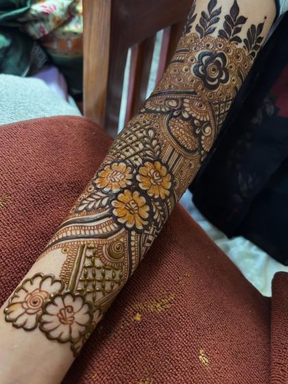 A close up of a floral band on the arm, showing how I mix different flower sizes and styles for a dynamic look.