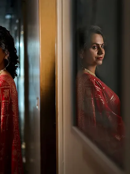 An artistic portrait of the bride-to-be at her engagement, using reflections to create a thoughtful and beautiful image.