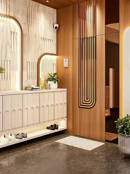 We designed this elegant foyer to be both welcoming and practical. The space features a custom console with integrated shoe storage, arched mirrors, and soft backlighting to create a warm and organized first impression.
