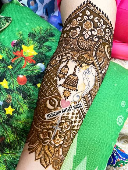 This custom design features a Ganesha motif for blessings, along with temple bells (ghanti) and a hidden initial. It's a deeply spiritual and personal design.