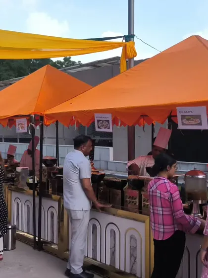 A wide view of our food stalls at an outdoor gathering. The setup is designed for easy access and flow, allowing guests to browse the different food options comfortably.