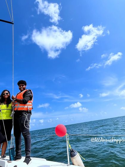 A stunning wide shot of the couple on the yacht, with a heart-shaped cloud seemingly celebrating with them.