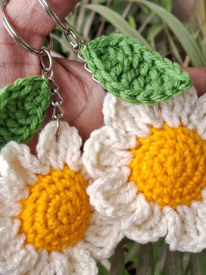 Our cheerful daisy crochet keychains. These small, handmade items are a symbol of strength and beauty, making them a perfect, meaningful gift to celebrate the women in your life.